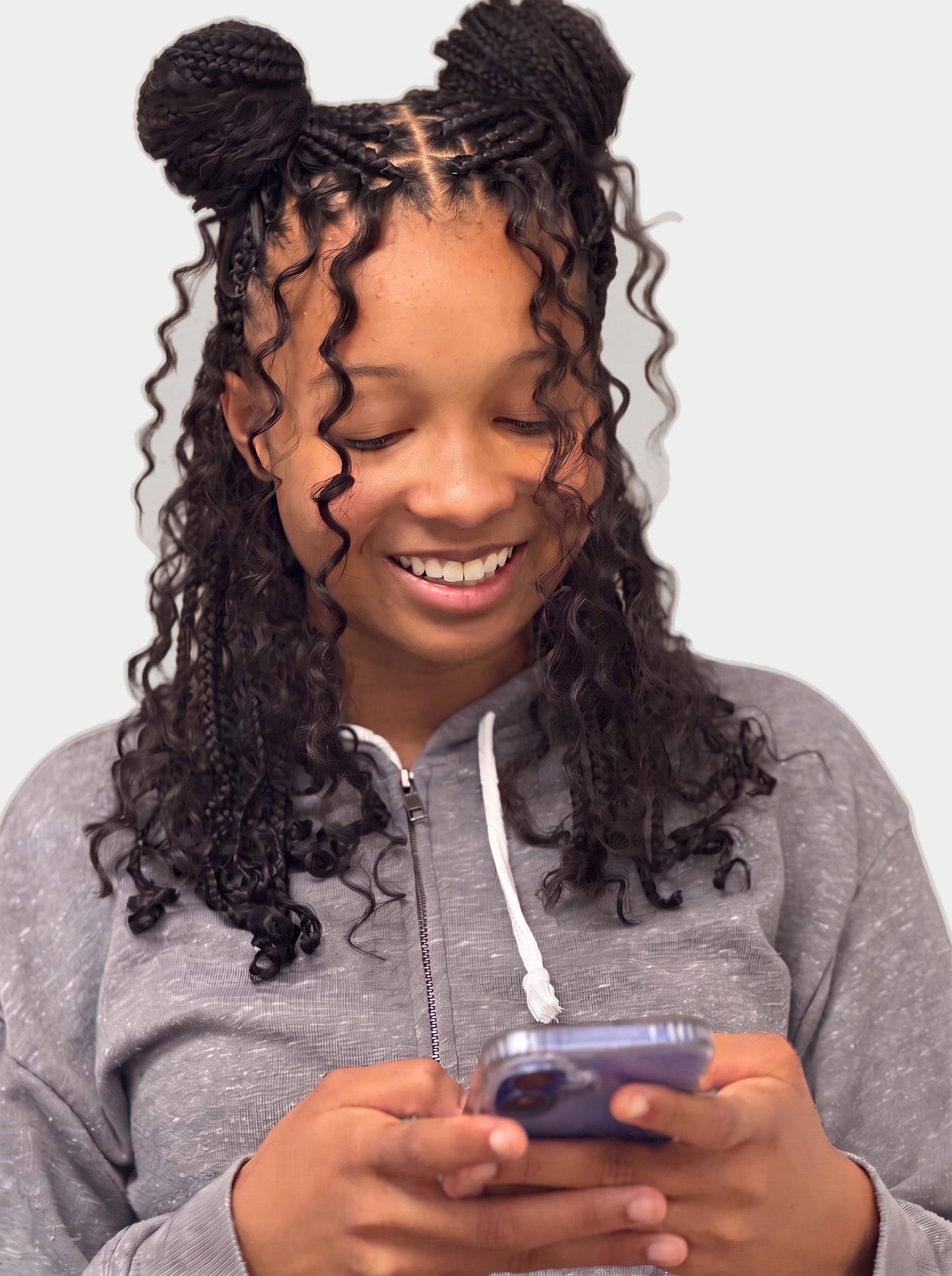 Boho knotless braids styled in two buns with curls