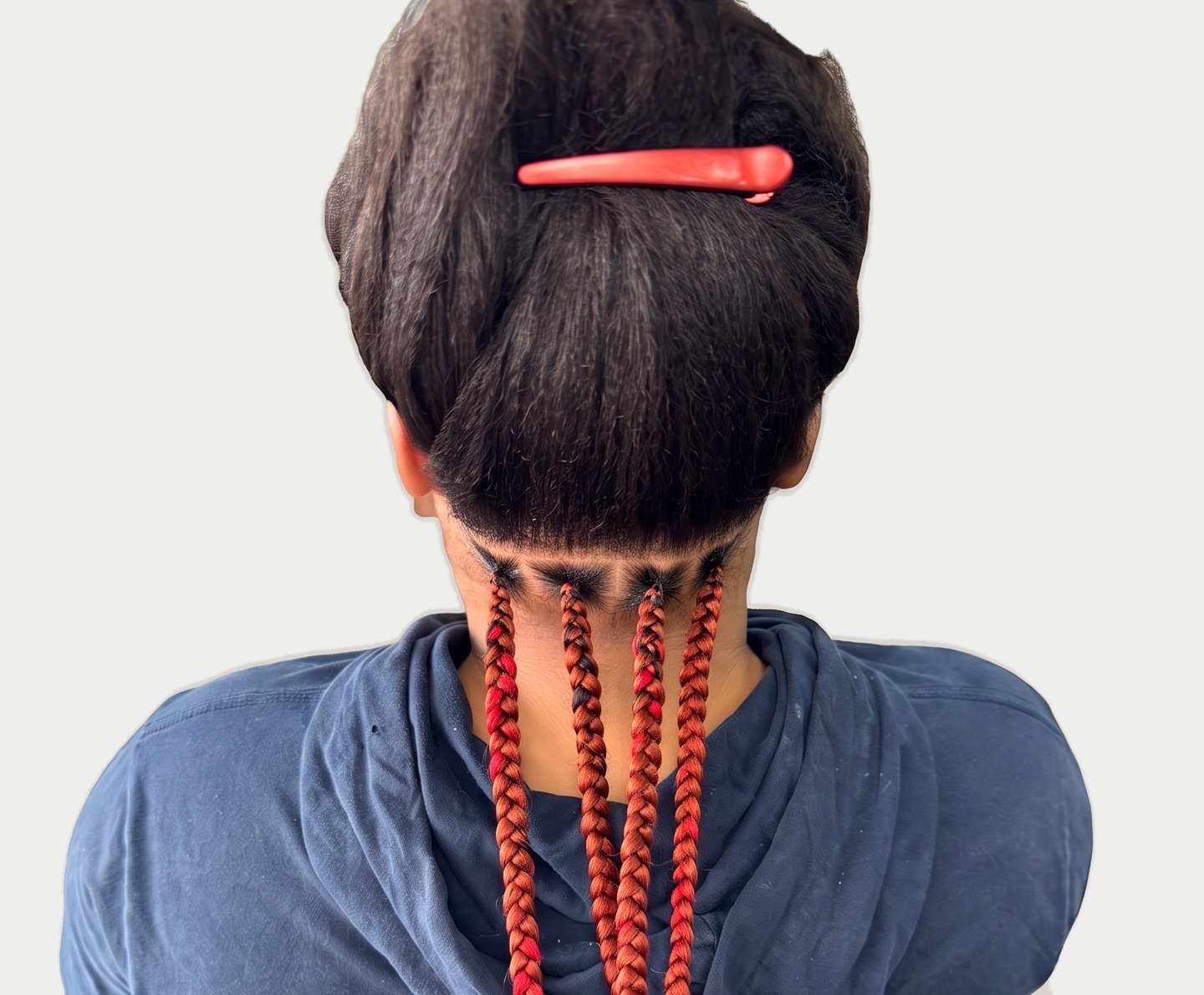 Back view of freshly parted knotless braids in copper and red tones