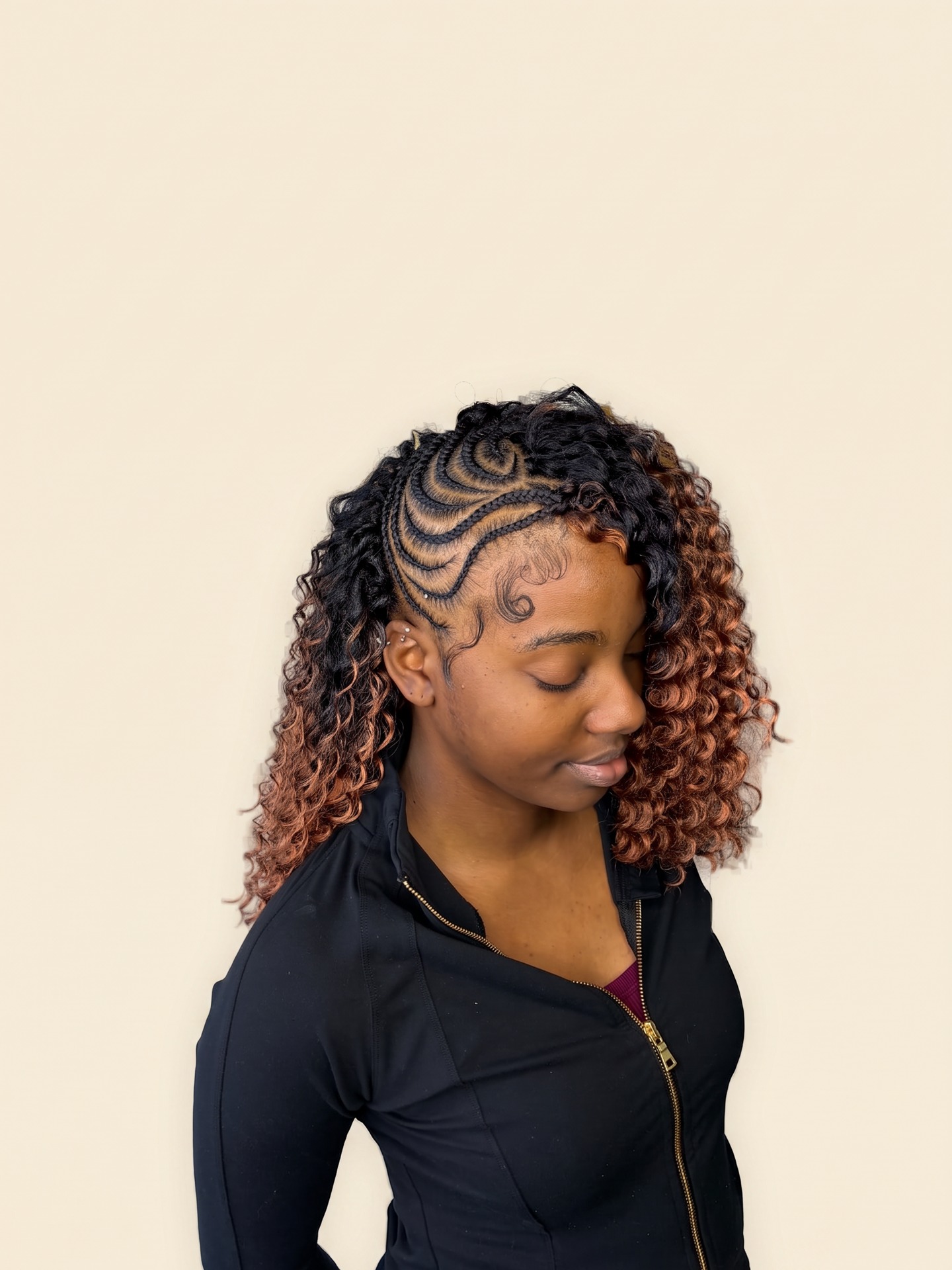 Pretty Braids client with ombré spiral curl braids and sculpted baby hairs on a cream background